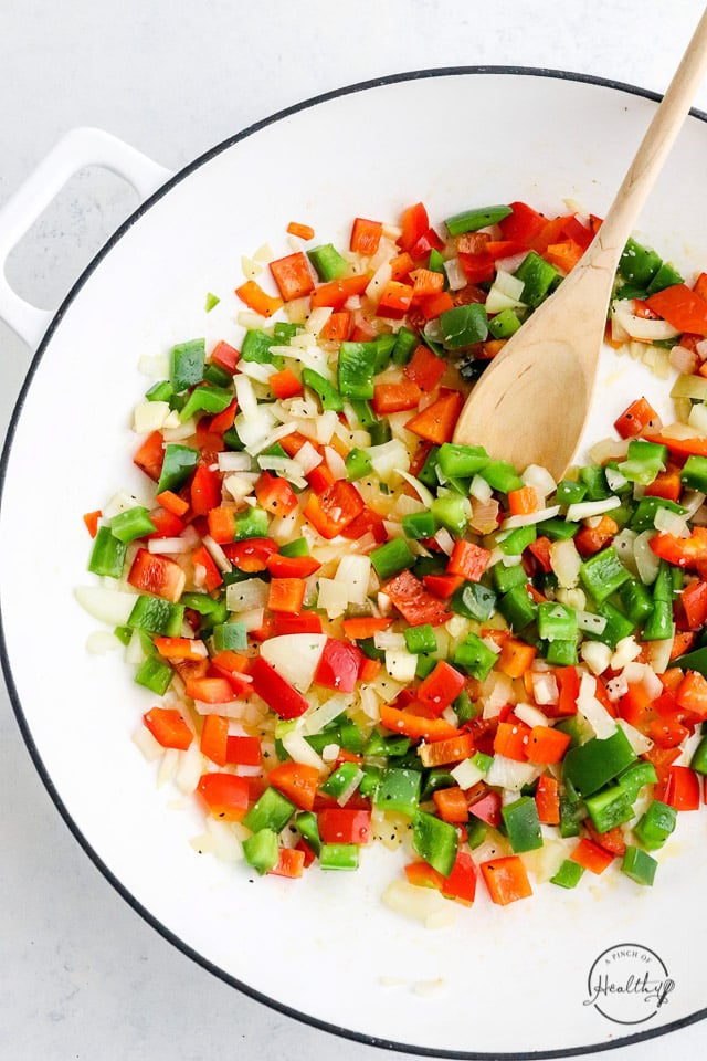 cooking peppers and onions in a pan
