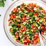 black eyed pea salad in a serving bowl on white surface