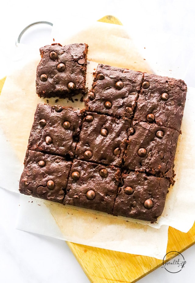 vegan brownies sliced on parchment paper