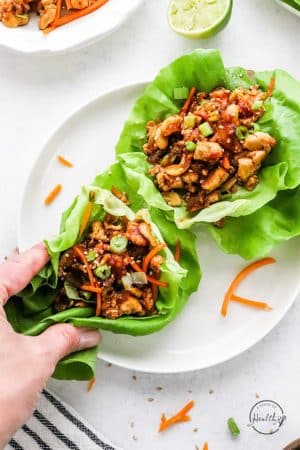 hand grabbing a tofu lettuce wrap