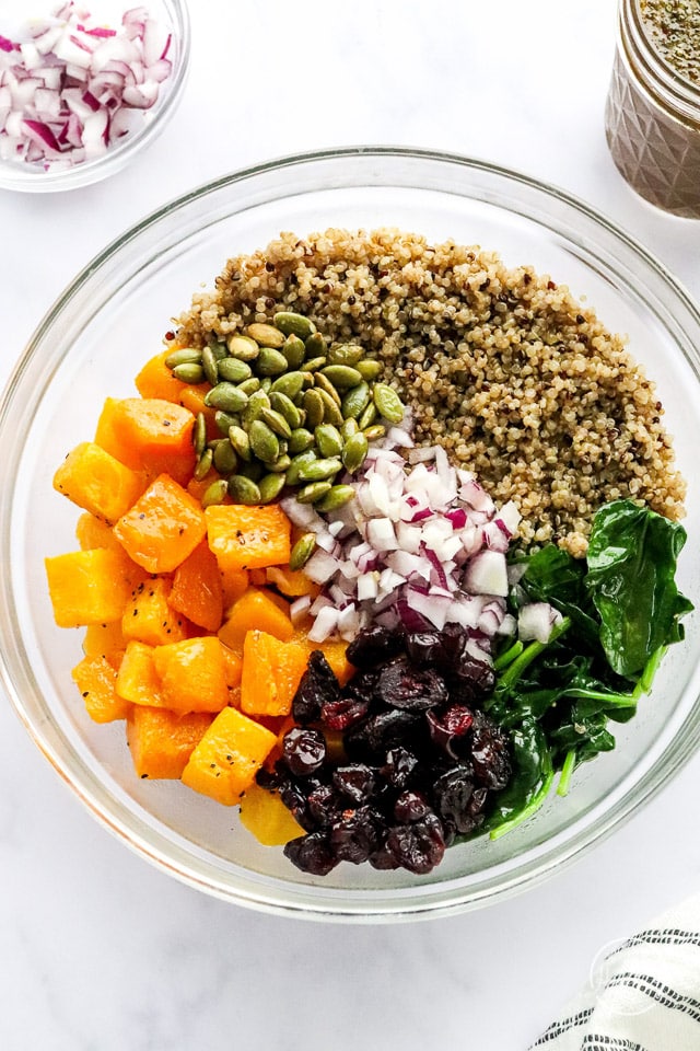 quinoa salad components in separate piles prior to mixing