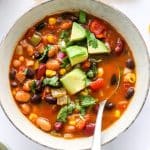 closeup of vegan taco soup topped with diced avocado