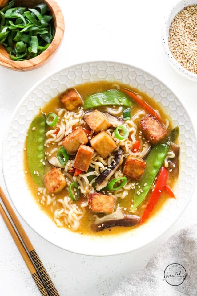 vegan ramen in a bowl with chopsticks on the side