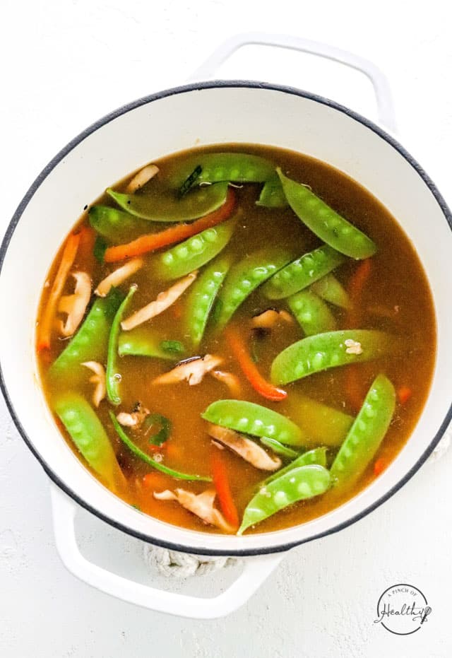 veggies and broth cooking in a pot