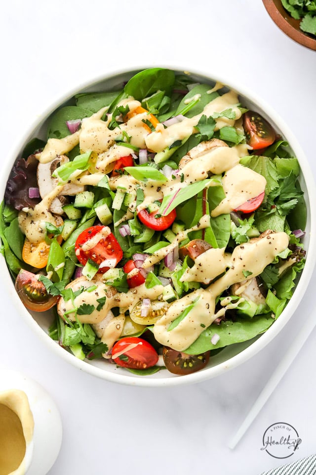 Tahini Dressing drizzled on a big salad 