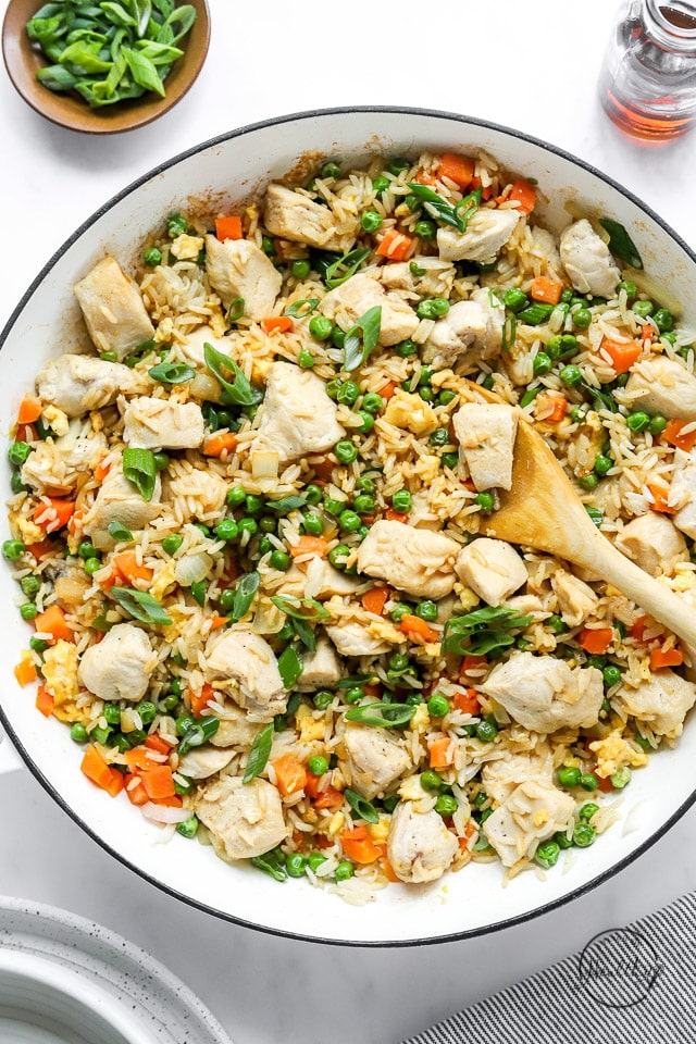 cooking chicken fried rice in a pan