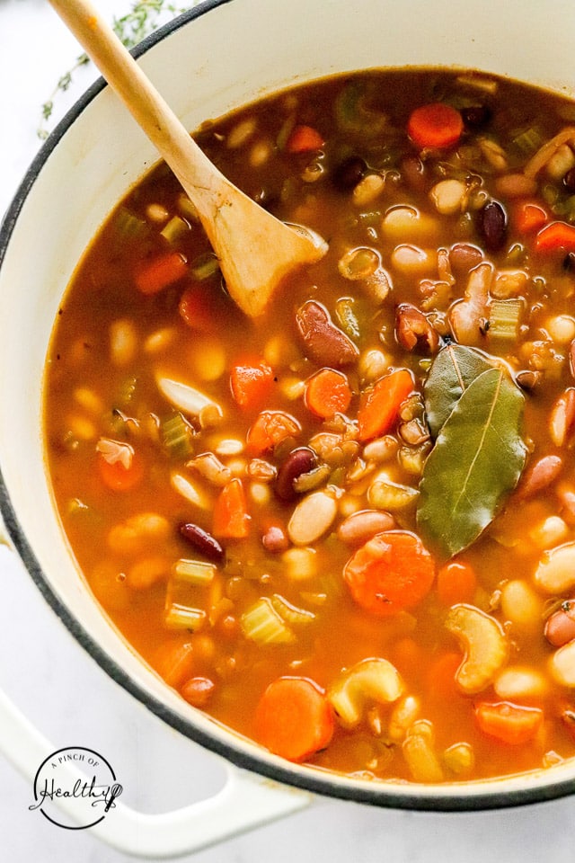 vegetarian 15 bean soup in a pot with bay leaves