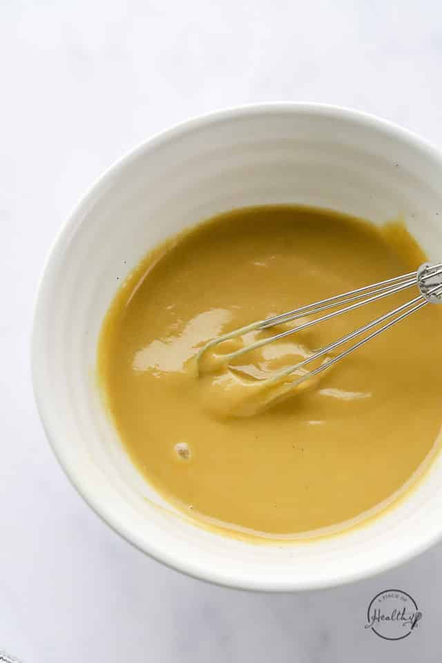 whisking tahini dressing ingredients to combine