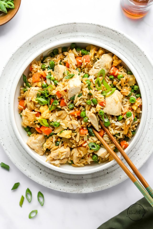 chicken fried rice in a bowl with chopsticks