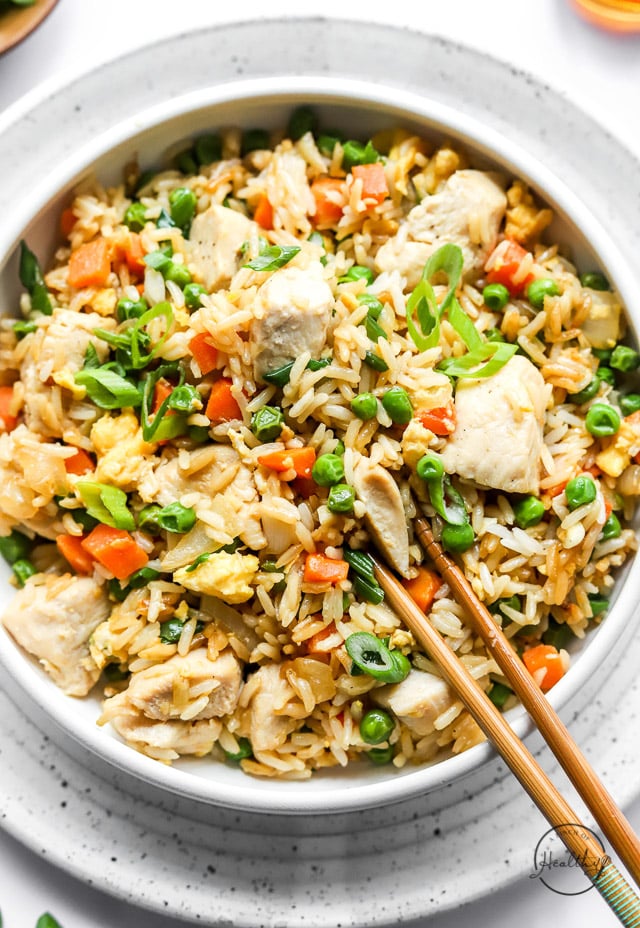 chicken fried rice in a bowl with chopsticks