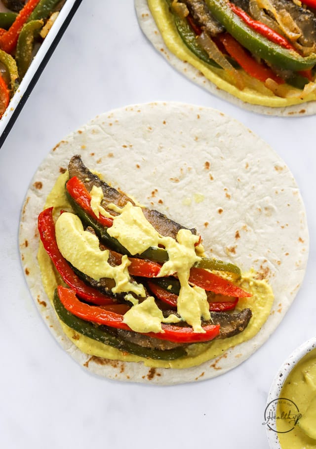 adding cashew cheese sauce to vegan quesadilla