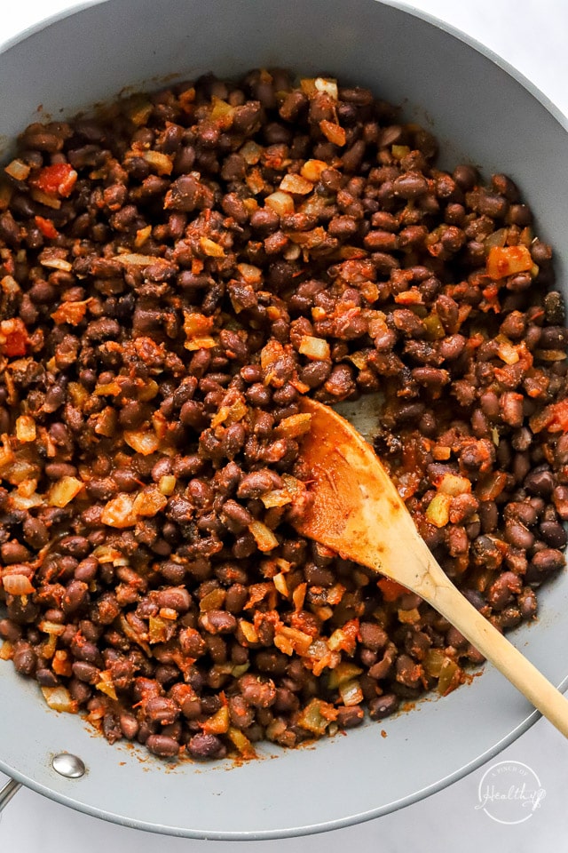 cooking veggies and beans in a pan