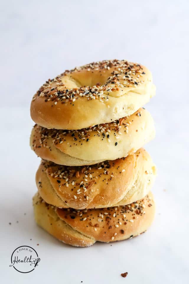 everything bagels stacked on white surface