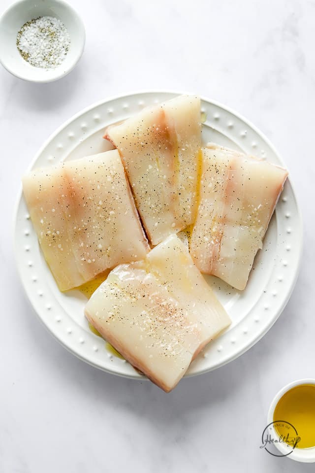 seasoned raw halibut on a plate