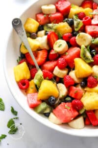 Fruit Salad Recipe made in a big serving bowl with spoon