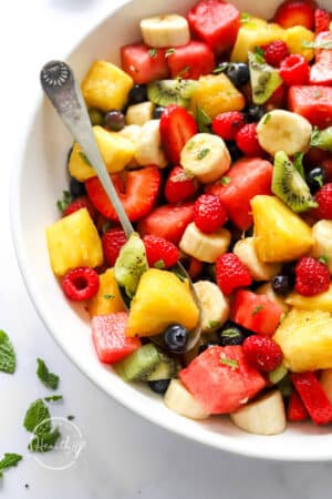 Fruit Salad Recipe made in a big serving bowl with spoon