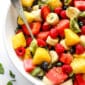 Fruit Salad Recipe made in a big serving bowl with spoon
