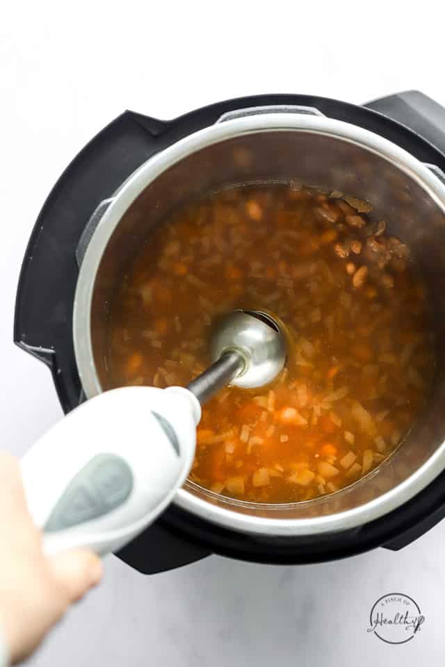 blending cooked pinto beans with immersion blender in the Instant Pot