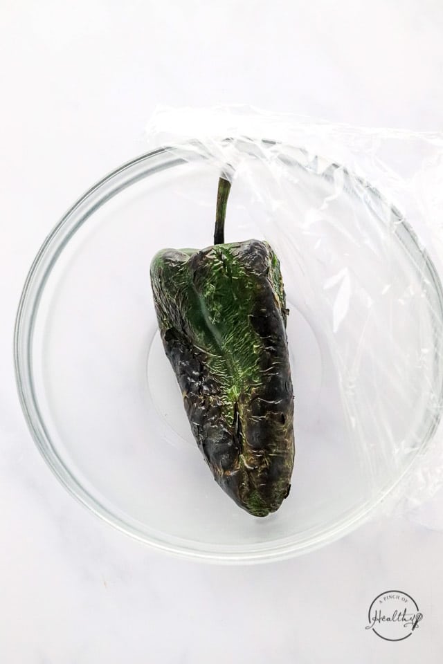 charred poblano pepper in a bowl