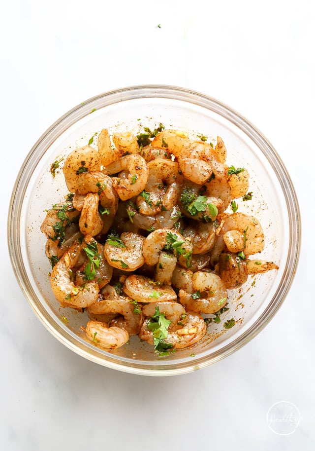 raw shrimp marinating in a bowl