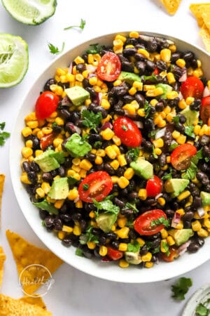 closeup of black bean salad in a white serving bowl