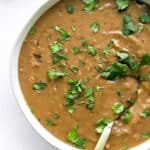 instant pot refried beans in a serving bowl with spoon
