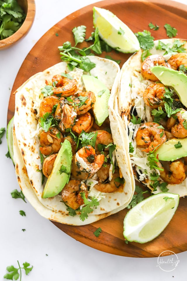 closeup of shrimp tacos on a wood board