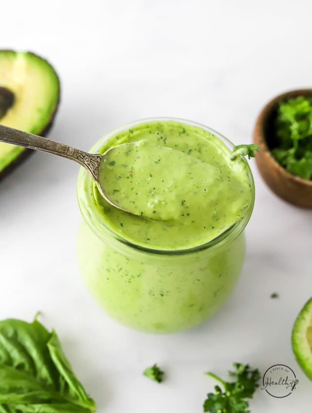 Green Goddess Dressing in a jar with spoon