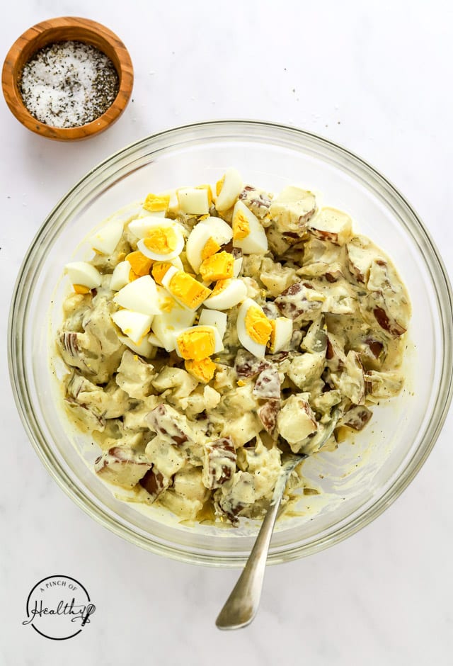 mixing Instant Pot potato salad in a bowl