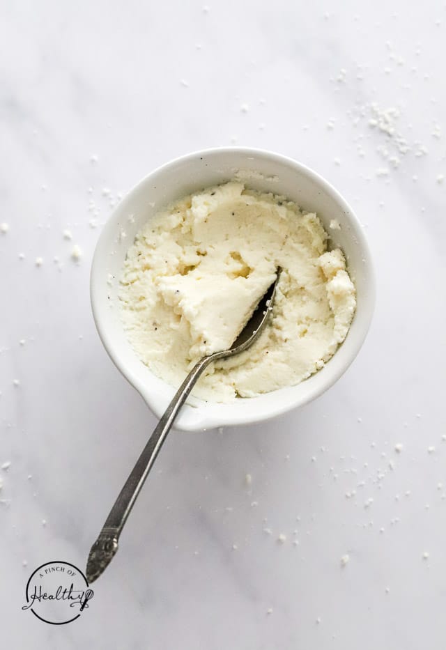 ricotta and parmesan mixture in a bowl with spoon