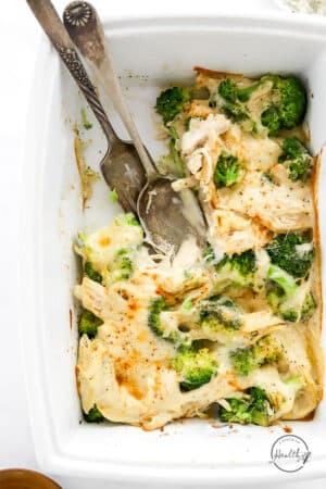 chicken divan in a baking dish with serving scooped out