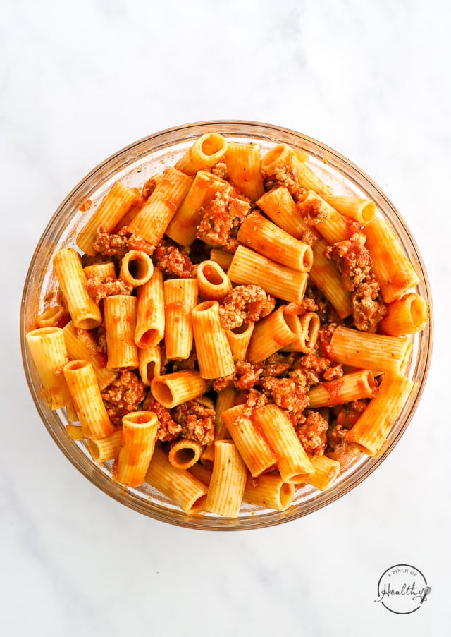 combining baked rigatoni filling in a bowl