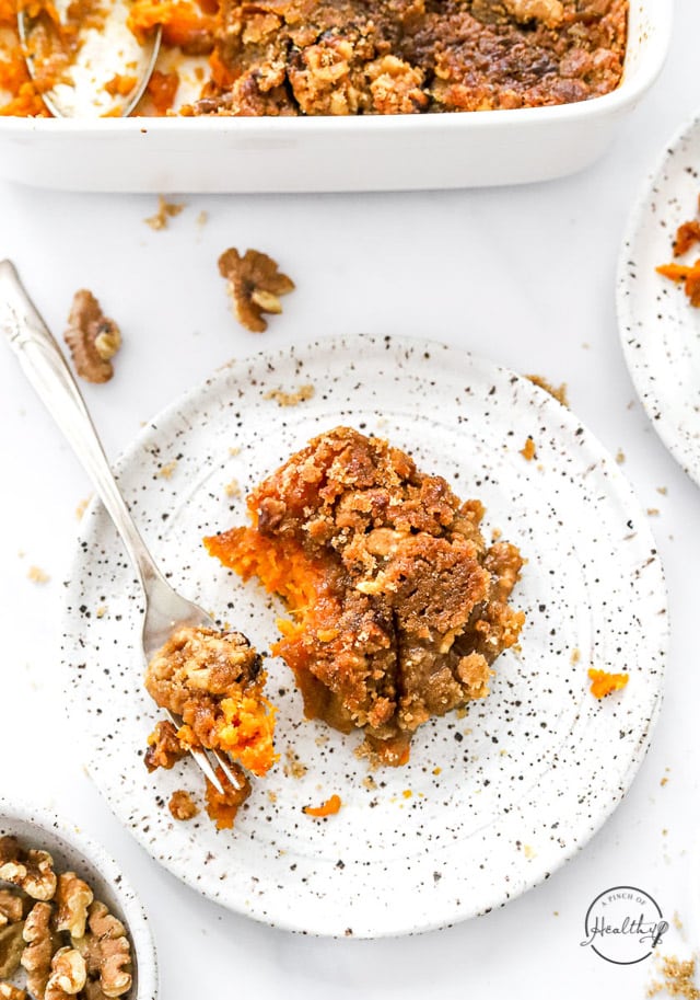 a serving of sweet potato casserole on a speckled plate with fork