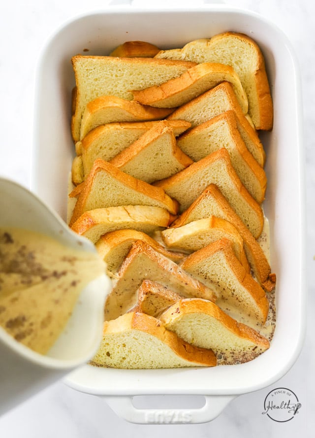 pouring milk and egg mixture over bread slices