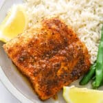closeup air fryer mahi mahi on a plate with lemon wedge, rice and green beans