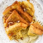 styled baked French toast on a plate with fork and maple syrup