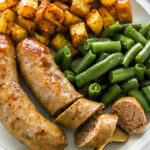 air fryer bratwurst on a plate with veggies