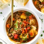 Cabbage Roll Soup in a white bowl with spoon