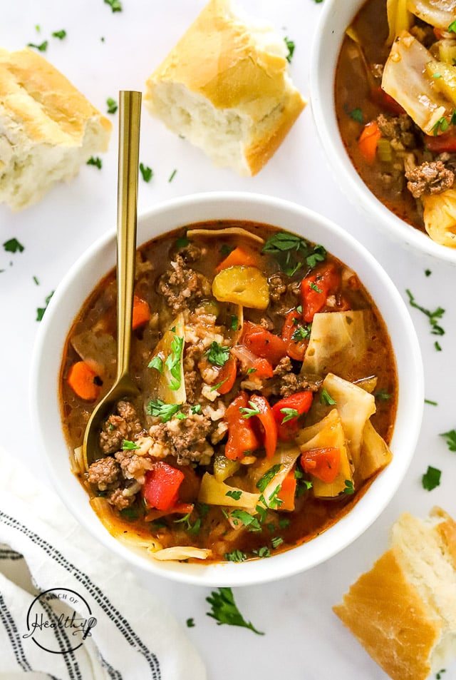 Cabbage Roll Soup in a white bowl with spoon