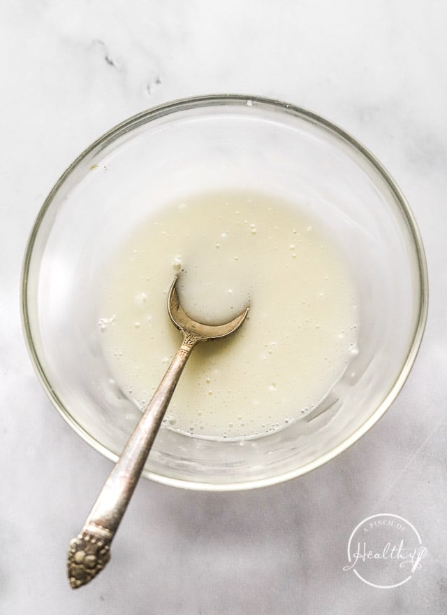 lemon glaze in a bowl with spoon