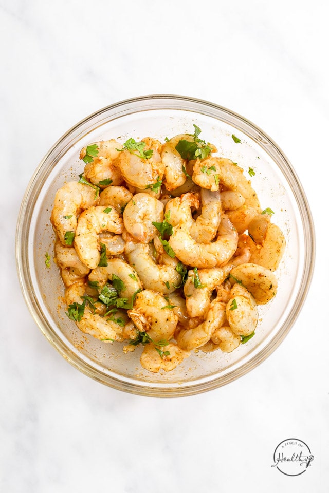 raw shrimp marinating in a bowl