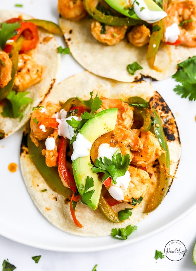 Three Shrimp Fajitas on a white plate