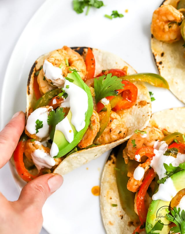 hand picking up a shrimp fajita