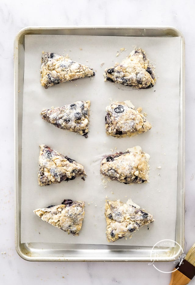 unbaked lemon blueberry scones on a baking sheet lined with parchment