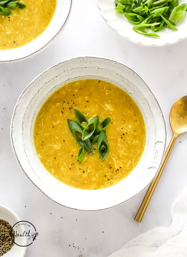 Styled egg drop soup in bowls with spoon