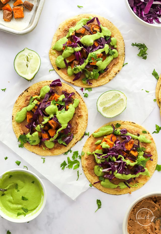 Open sweet potato tacos styled on a white surface