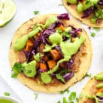Sweet Potato Tacos with avocado crema on white parchment