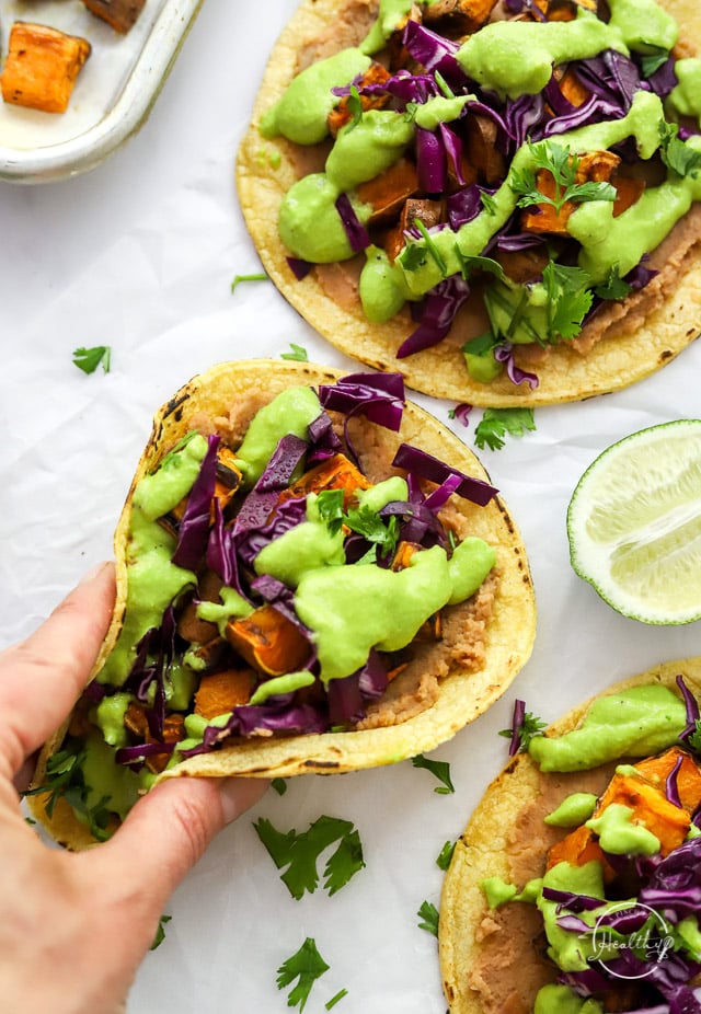 Hand grabbing a sweet potato taco