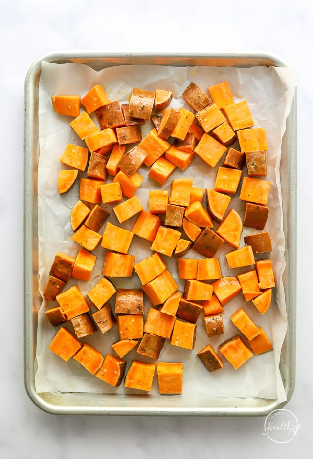 raw sweet potatoes on a baking sheet