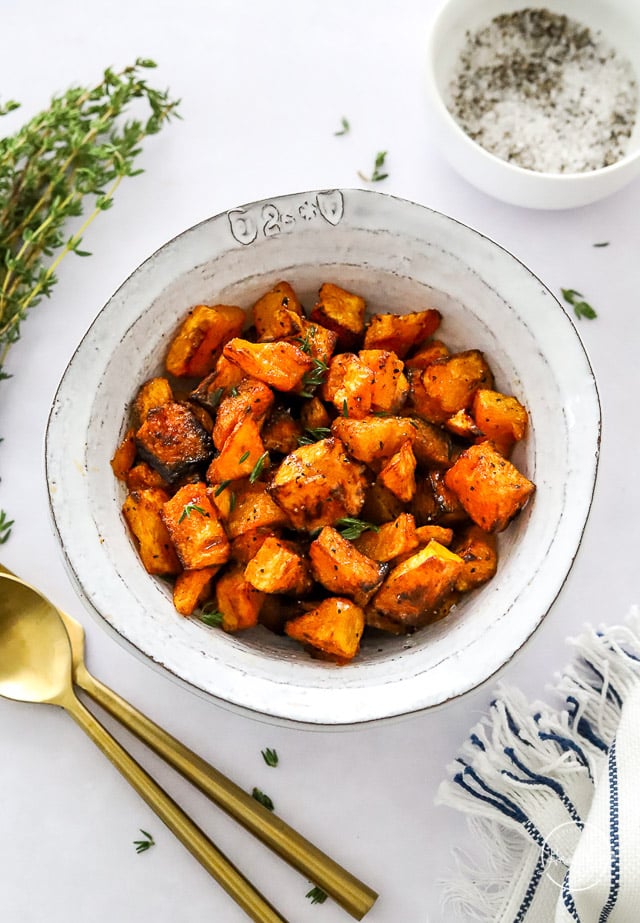air fryer butternut squash in a white serving bowl